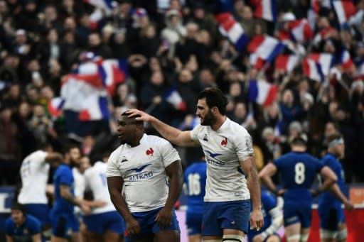 France's captain Charles Ollivon gives prop Demba Bamba a pat on the head as France celebrate against Italy