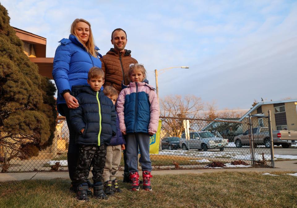 Ukrainian refugees Nazar Volianiuk, 31, his wife Natalia Voianuik, 32 and three children stand in front of their apartment in Chicago.