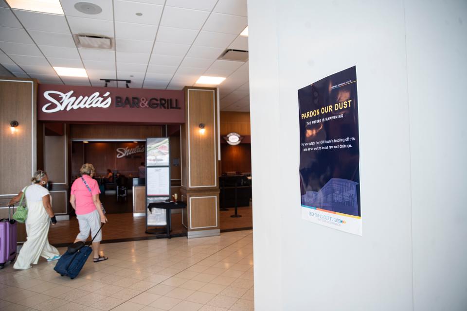 Passengers and others walk past ongoing construction at Southwest Florida International Airport on Tuesday, May 31, 2022. 