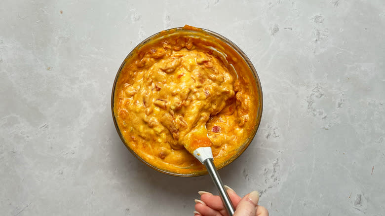 stirring melted queso