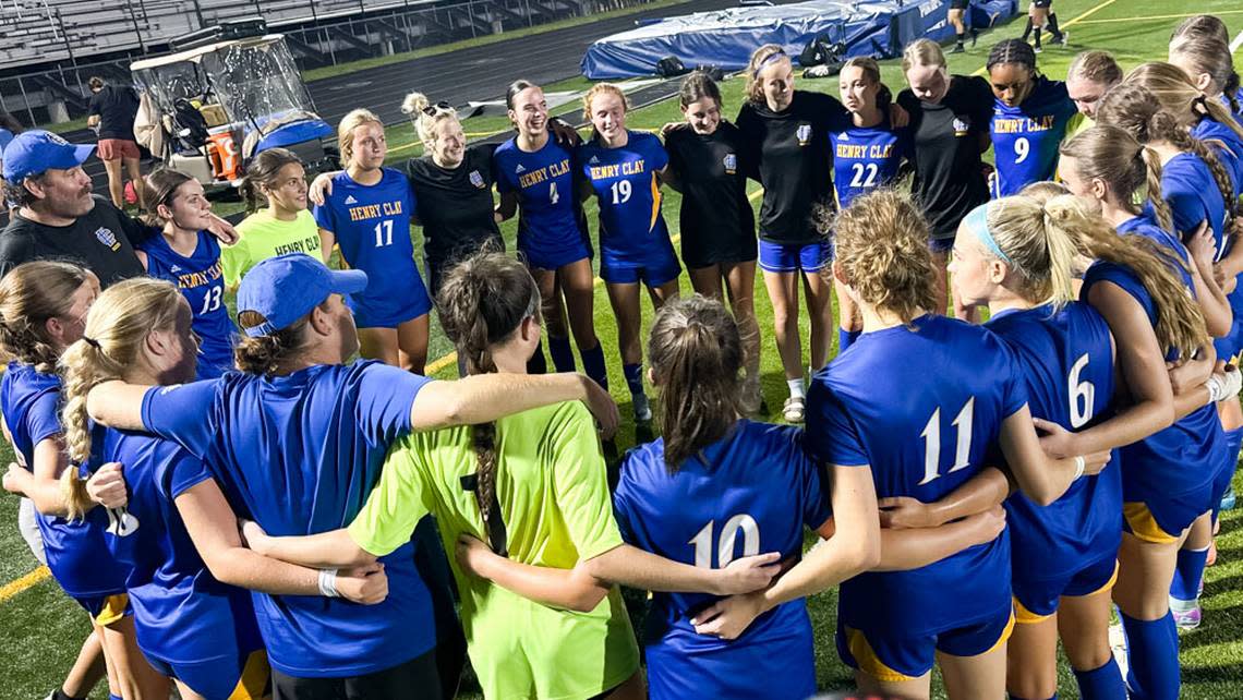 Henry Clay players circle for their postgame talk after the Blue Devils earned a 1-1 tie against Lexington Catholic on Wednesday.