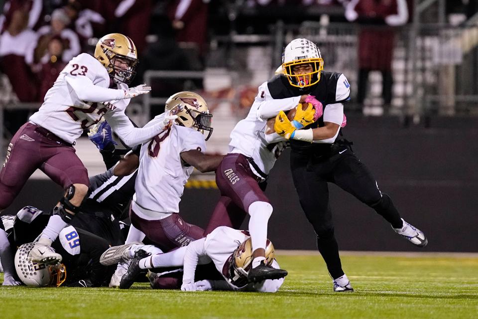 Nov 18, 2022; Columbus, Ohio, USA;  Gahanna's Diore Hubbard (4) runs through the New Albany Eagles defensive line during the second half of the high school football Div. I regional final at Historic Crew Stadium. Gahanna won 25-17. Mandatory Credit: Adam Cairns-The Columbus Dispatch