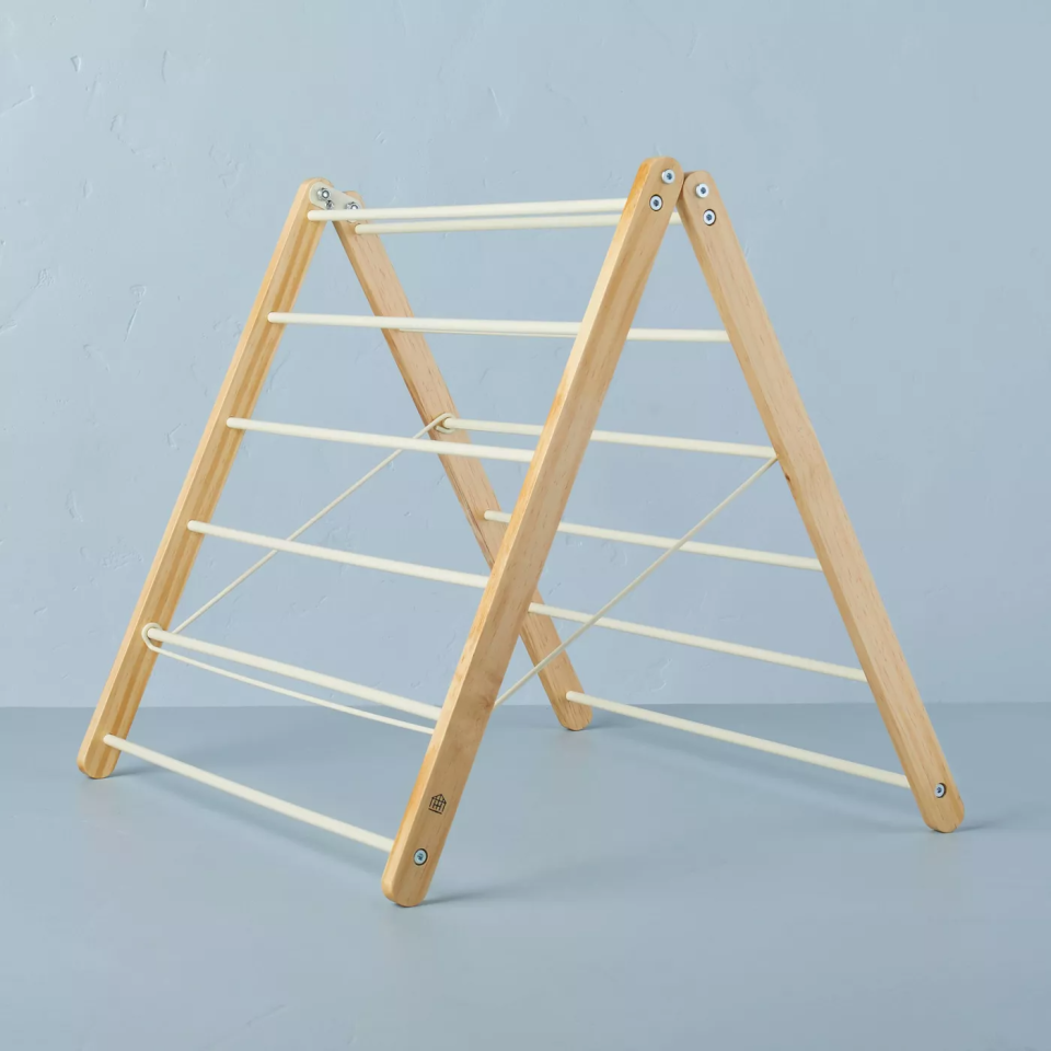 folding drying rack on blue backdrop