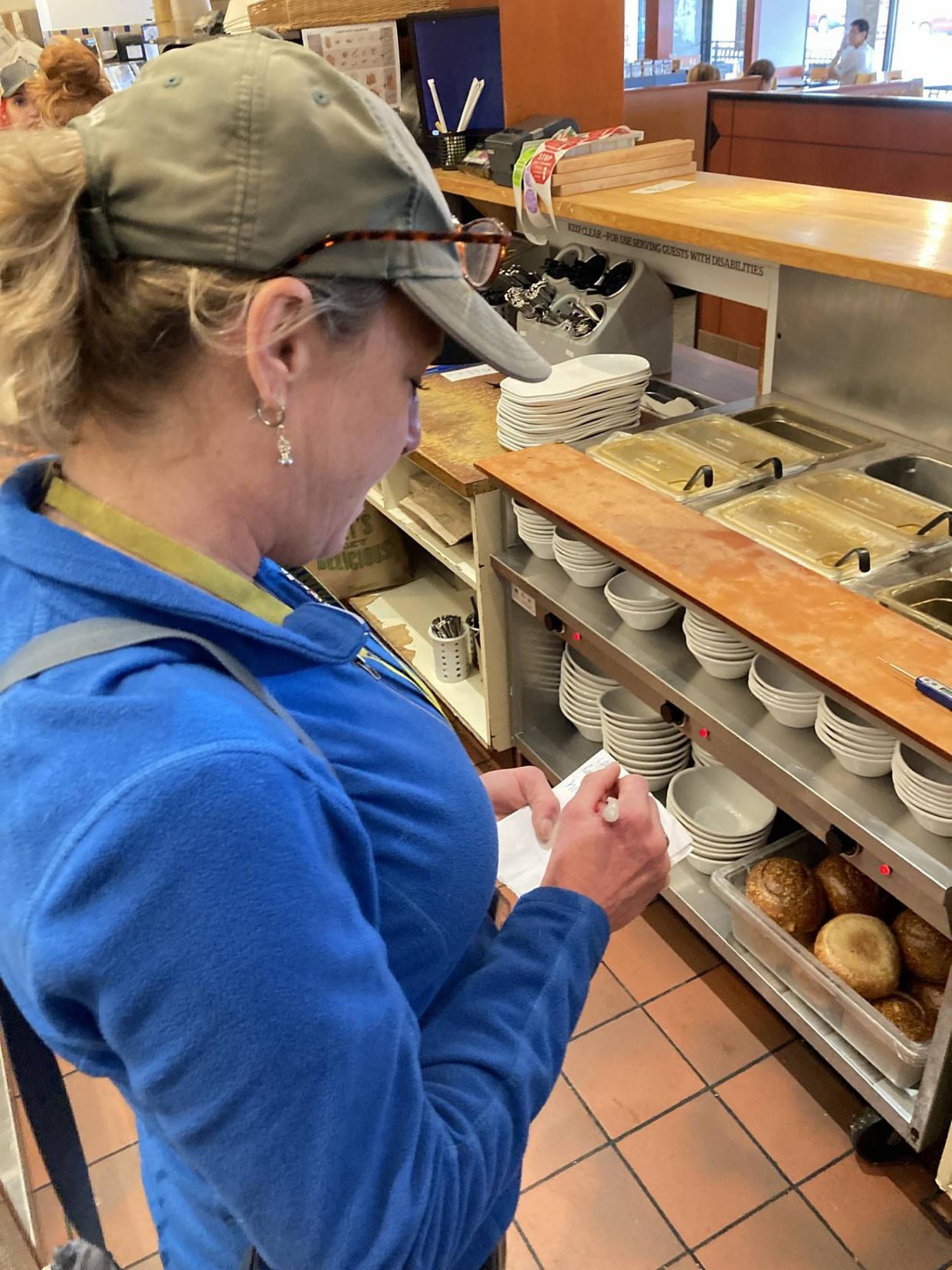 Lisa Susann jots notes from her health inspection of Panera Bread, 2501 W. 12th St., on April 18. Susann is an environmental protection specialist for the Erie County Department of Health.