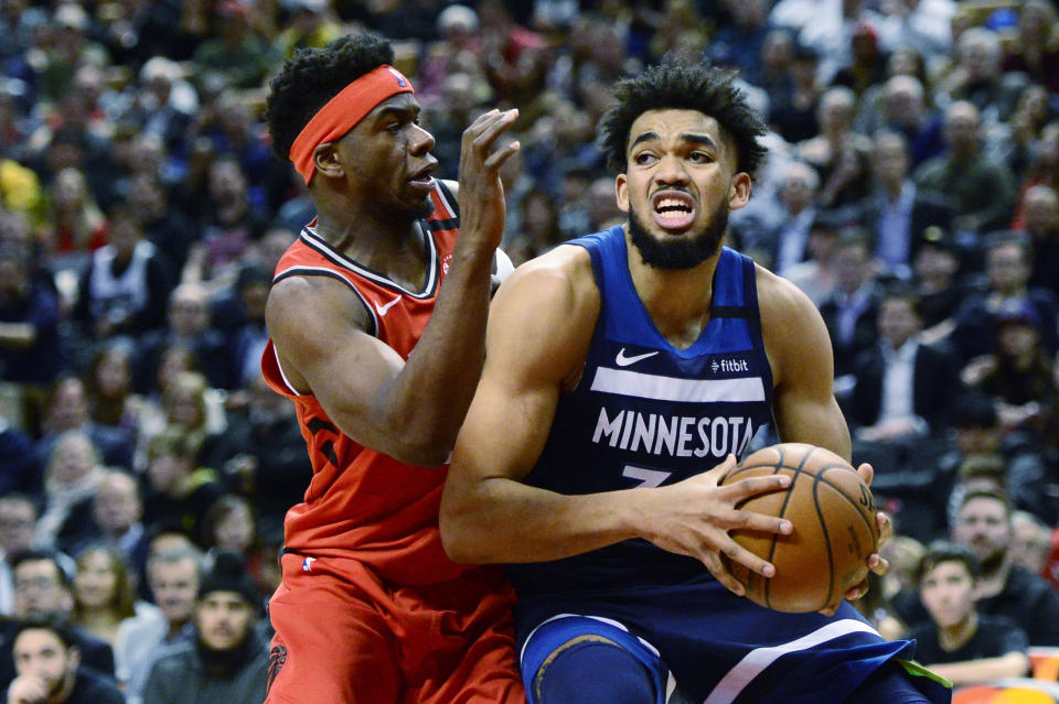 Toronto Raptors guard Terence Davis (0) guards Minnesota Timberwolves centre Karl-Anthony Towns (32) during second half NBA basketball action in Toronto, Monday, Feb. 10, 2020. (Frank Gunn/The Canadian Press via AP)