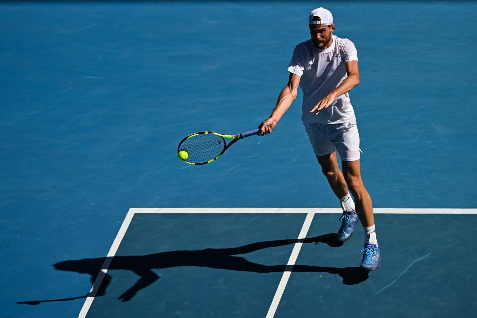 MELBOURNE, AUSTRALIA - JANUARY 24: Maxime Cressy of the United States hits a forehand against Daniil Medvedev of Russia during day eight of the 2022 Australian Open at Melbourne Park on January 24, 2022 in Melbourne, Australia. (Photo by TPN/Getty Images)