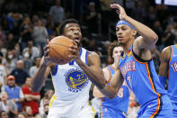 Golden State Warriors forward Andrew Wiggins (22) goes to the basket against Oklahoma City Thunder forward Darius Bazley (7) in the first half of an NBA basketball game Tuesday, Oct. 26, 2021, in Oklahoma City. (AP Photo/Nate Billings)