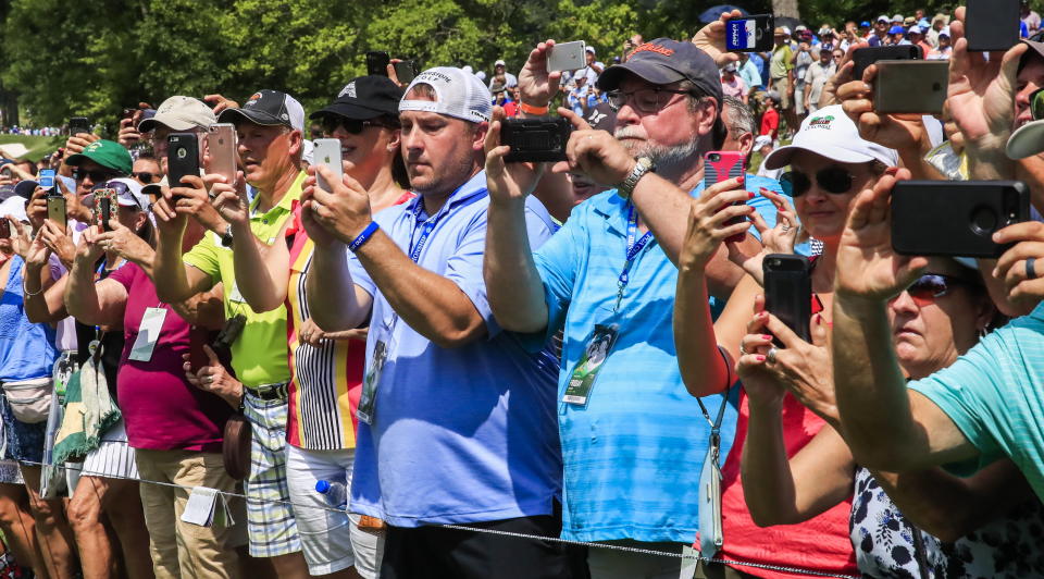 Fans photograph Tiger Woods during the 100th PGA Championship golf tournament at Bellerive Country Club in St. Louis, Missouri. (EFE)