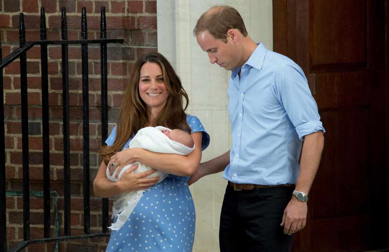 Britain's Prince William, right, and Kate, Duchess of Cambridge hold the Prince of Cambridge, Tuesday July 23, 2013, as they pose for photographers outside St. Mary's Hospital exclusive Lindo Wing in London where the Duchess gave birth on Monday July 22. The boy, who is third in line to the British throne, has since been named George Alexander Louis by his parents and will be known as Prince George of Cambridge. (Photo by Joel Ryan/Invision/AP)