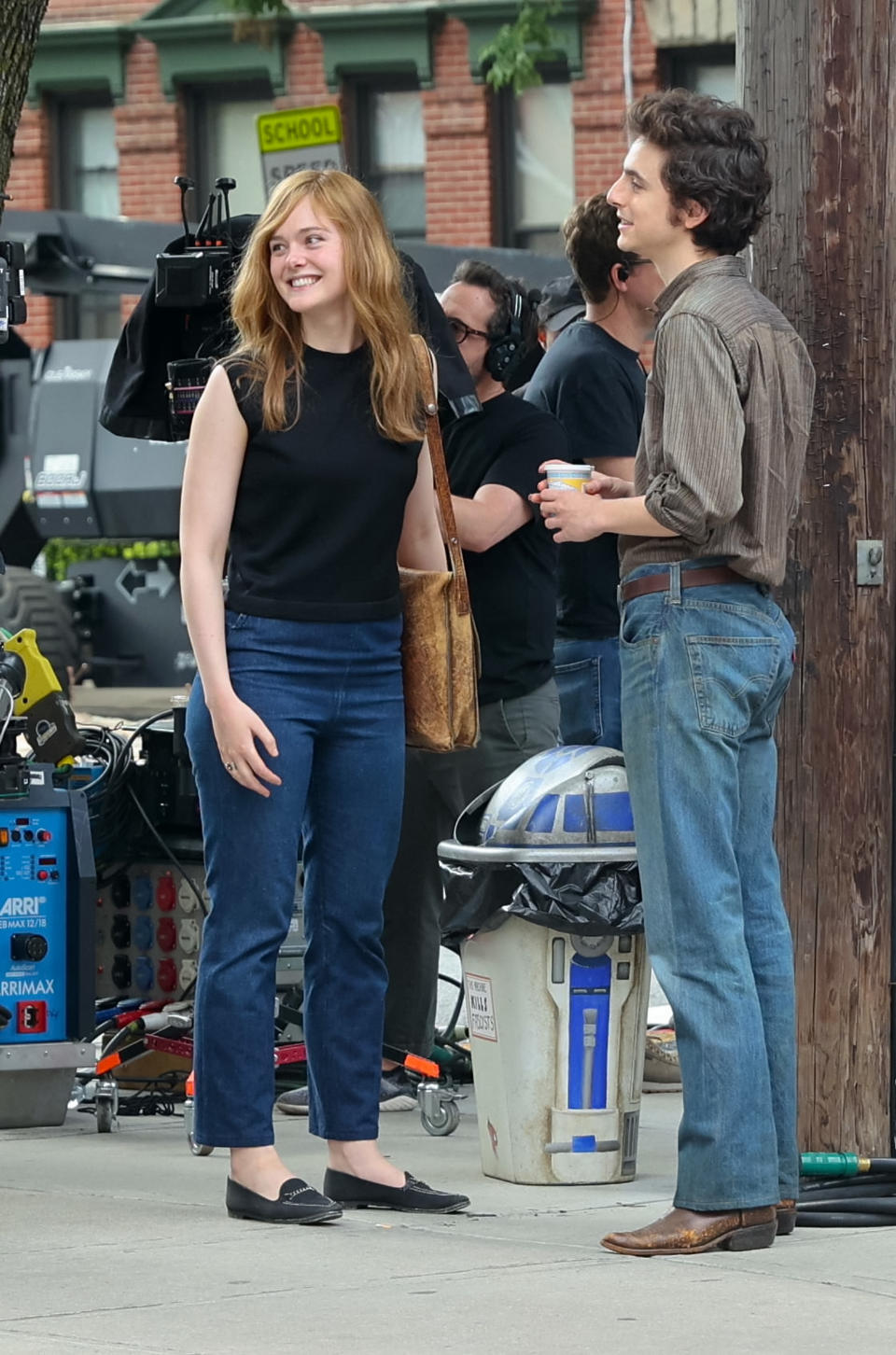 Elle Fanning, Timothee Chalamet, movie set, film set, costume, black flats, brown leather boots, shoes