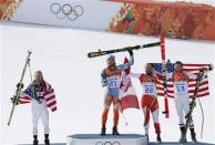 Norway's winner Kjetil Jansrud (2nd L), second-placed Andrew Weibrecht of the U.S. (L) and joint third-placed Bode Miller of the U.S. (R) and Canada's Jan Hudec pose on podium during a flower ceremony after the men's alpine skiing Super-G competition during the 2014 Sochi Winter Olympics at the Rosa Khutor Alpine Cente February 16, 2014. REUTERS/Mike Segar