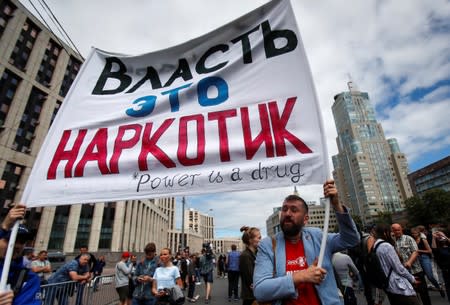 A man holds a banner during a rally organised by Union of Journalists in support of the investigative journalist Ivan Golunov in Moscow