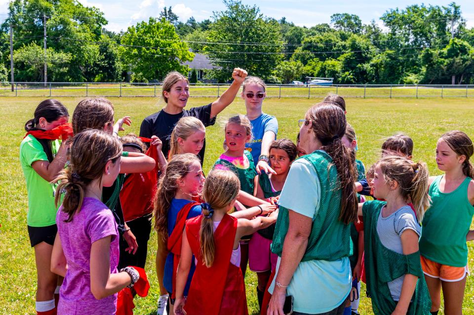 Meg Hughes brings her campers in for a chant at the MATTREC Girls Soccer Clinic held at Old Rochester.