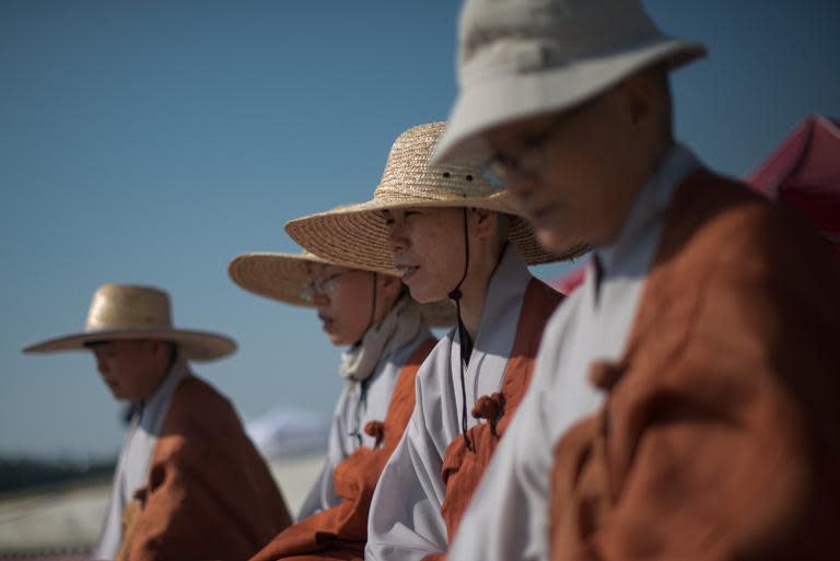 Monks conduct a prayer service for victims of the 'Sewol' ferry at Jindo harbour on April 24, 2014