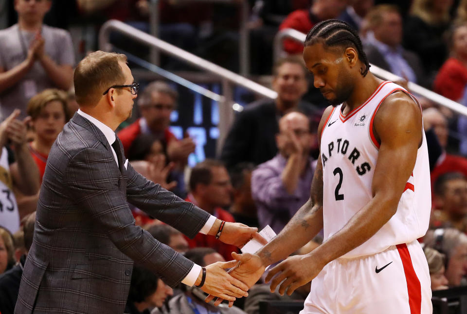 TORONTO, ONTARIO - MAY 21: Kawhi Leonard #2 of the Toronto Raptors high fives head coach Nick Nurse of the Toronto Raptors in game four of the NBA Eastern Conference Finals against the Milwaukee Bucks at Scotiabank Arena on May 21, 2019 in Toronto, Canada. NOTE TO USER: User expressly acknowledges and agrees that, by downloading and or using this photograph, User is consenting to the terms and conditions of the Getty Images License Agreement. (Photo by Gregory Shamus/Getty Images)