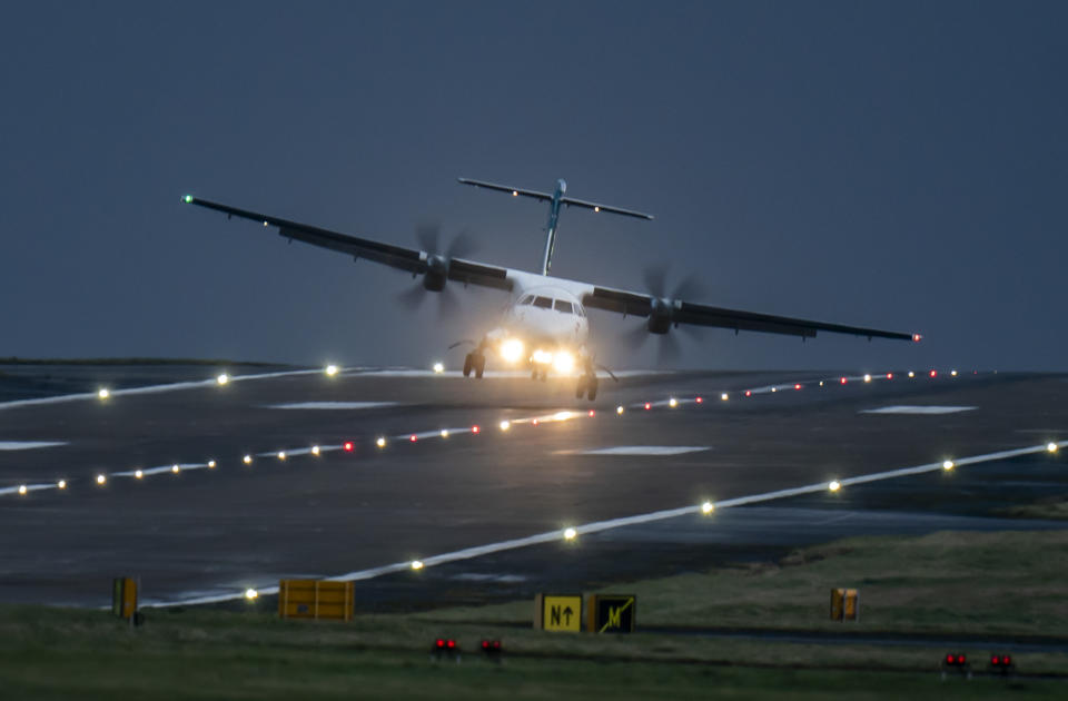 A aircraft lands at Leeds Bradford Airport during Storm Pia, which is expected to cause disruption in parts of Scotland, the north of England and Northern Ireland. Picture date: Thursday December 21, 2023. PA Photo. See PA story WEATHER Wind. Photo credit should read: Danny Lawson/PA Wire        