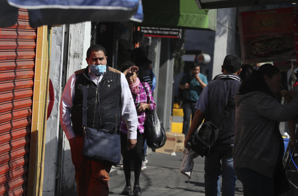 A man wears a mask over his mouth as a precaution against the spread of the new coronavirus in Mexico City, Friday, Feb. 28, 2020. Mexico’s assistant health secretary announced Friday that the country now has confirmed cases of the COVID-19 virus. (AP Photo/Fernando Llano)