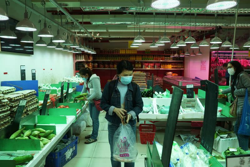 Customers wearing face masks shop at a market, following the outbreak of the coronavirus disease (COVID-19), at Sha Tin district, in Hong Kong
