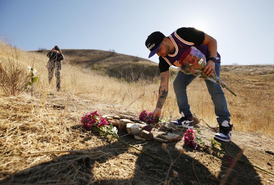 Anthony Calderon, 33, brought flowers and arranged rocks in a figure 8 on the mountainside in Calabasas.