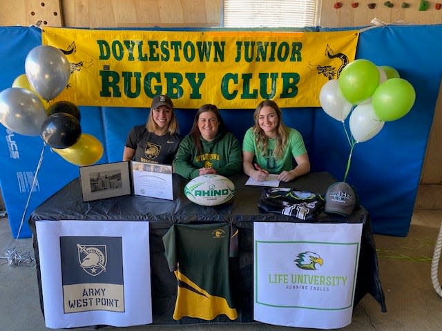 Rugby players Sophia Linder and Nina Mason signed to their respective programs as seniors in 2021. Head coach Stacy Mancuso sat with them in support.