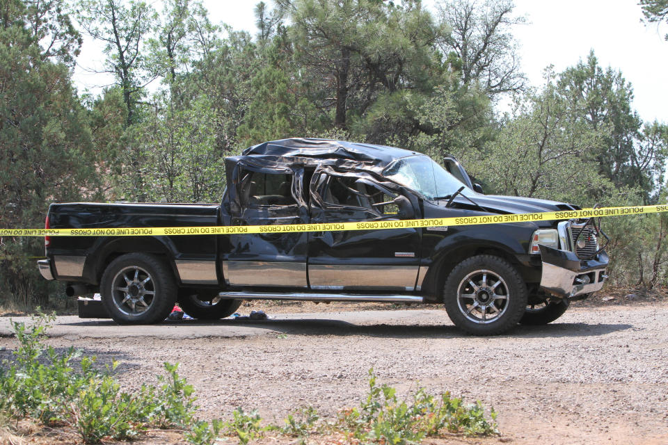 This Saturday, June 19, 2021, photo courtesy of The White Mountain Independent shows a damaged pickup truck which ran over a group of cyclists in Show Low, Ariz. A driver in a pickup truck plowed into bicyclists competing in a community road race in Arizona on Saturday, critically injuring several riders before police chased down the driver and shot him outside a nearby hardware store, police said. Police say the cyclists have been taken to a hospital in critical condition after the crash. (Jim Headley/The White Mountain Independent via AP)