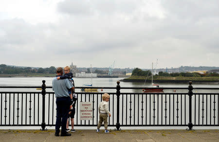 People look out at the River Medway in Chatham, Britain, August 8, 2017. REUTERS/Hannah McKay