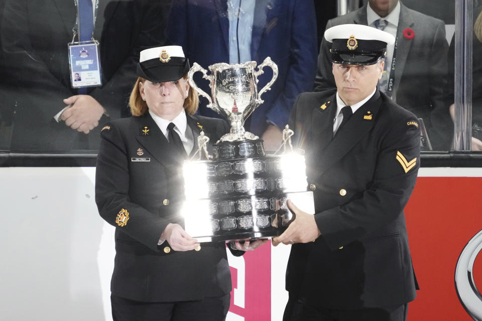 The memorial cup trophy is carried onto the ice prior to the first game of the Memorial Cup championship between the Hamilton Bulldogs and the host Saint John Sea Dogs in Saint John, Canada, on Monday, June 20, 2022. (Darren Calabrese/The Canadian Press via AP)