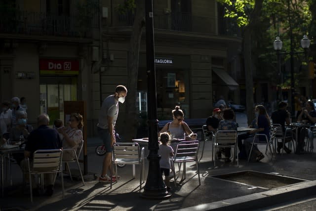 Local customers sit in a terrace bar in Barcelona (Emilio Morenatti/AP)