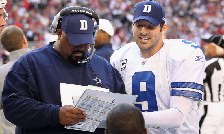 Dallas Cowboys coach Skip Peete and Tony Romo talk on sideline.
