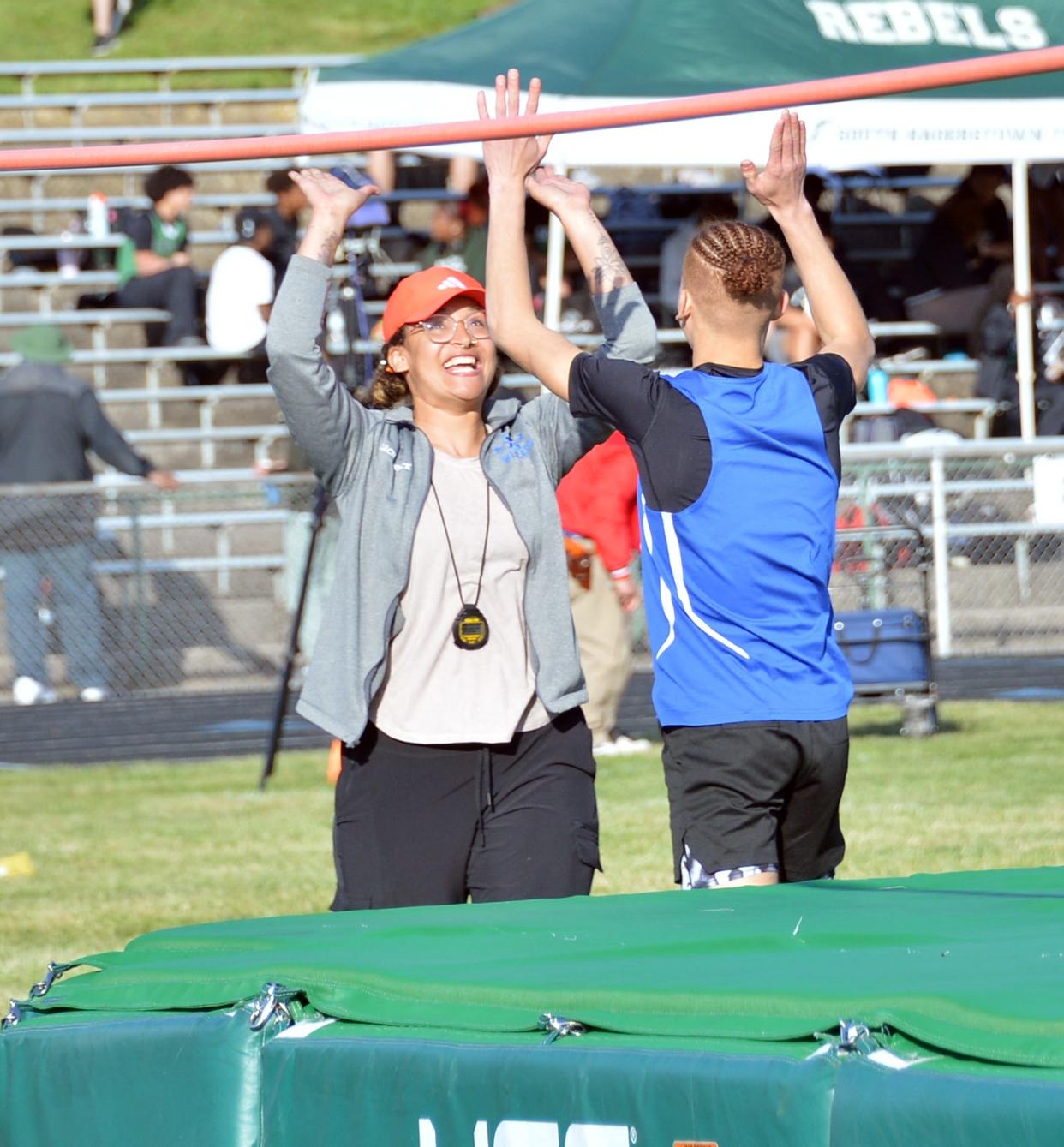 Williamsport's Masiah Martin is congratulated by coach Erin Minnick after clearing 6 feet in the high jump for the first time. Martin won the event.