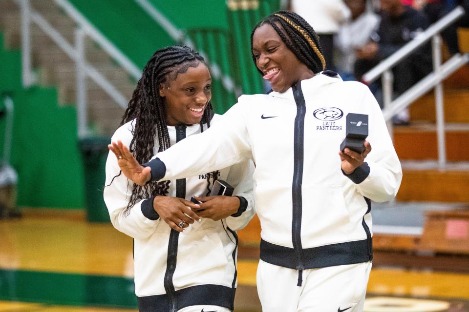 Washington's Monique Mitchell (35) shows off her ring to Ryiah Wilson (3) during the championship ring ceremony for the 2021-22 state championship team Tuesday, Nov. 15, 2022 at Washington High School.