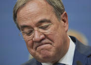 Armin Laschet, Federal Chairman of the CDU, top candidate of his party for Chancellor grimaces as he comments on the outcome of the Bundestag elections, at the Konrad Adenauer House, Berlin, Sunday, Sept. 26, 2021. Exit polls show the center-left Social Democrats in a very close race with outgoing Chancellor Angela Merkel's bloc in Germany's parliamentary election, which will determine who succeeds the longtime leader after 16 years in power. (Michael Kappeler/DPA via AP)