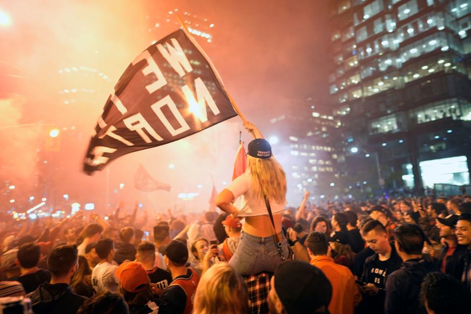 Toronto Raptors fans celebrate their win in the NBA championships in downtown Toronto, Ontario on early June 14, 2019. (Photo by Geoff Robins / AFP) (Photo credit should read GEOFF ROBINS/AFP/Getty Images)