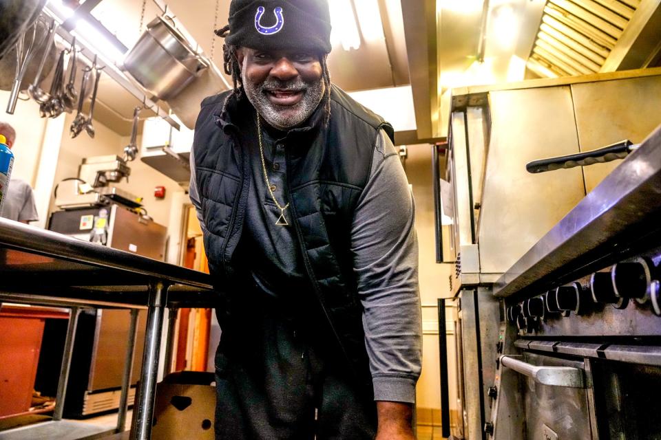 Noel Dandy checks a roasting turkey in the oven at Mathewson Street United Methodist Church in Providence, where he volunteers five days a week.