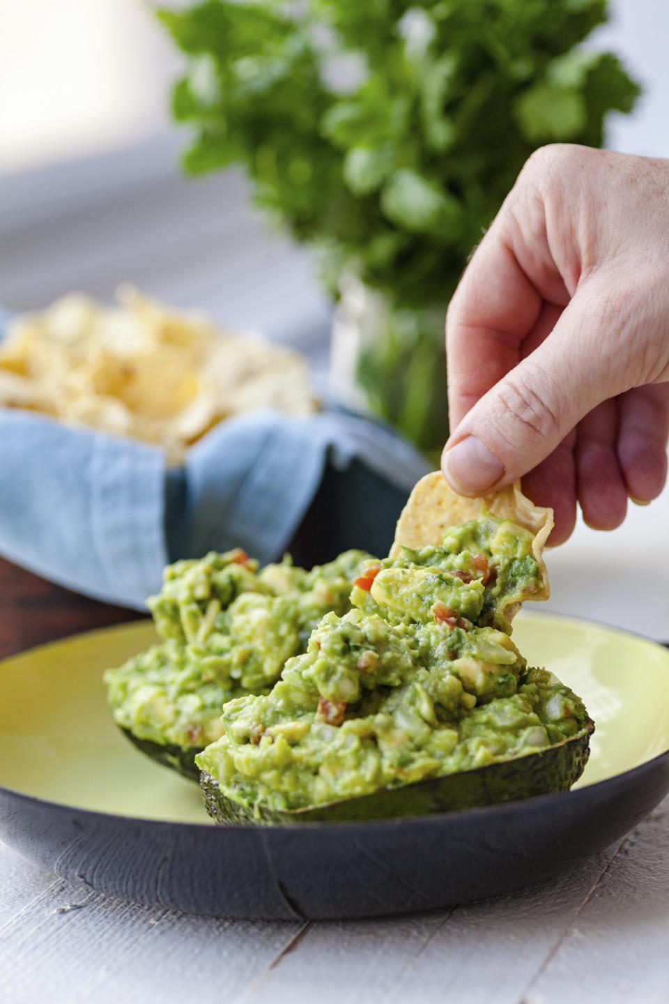 A recipe for guacamole, served in an avocado shell, appears in New York in June 2019. (Carrie Crow via AP)