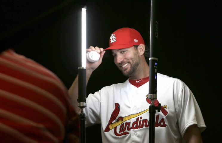 St. Louis Cardinals' Adam Wainwright adjusts his cap as he poses for a photographer during picture day before a spring training baseball workout Monday, Feb. 20, 2017, in Jupiter, Fla. (AP Photo/David J. Phillip)