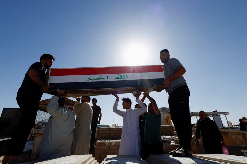 Men carry coffin of an Iraqi soldier at the Wadi al-Salam cemetery, Arabic for "Peace Valley", in Najaf