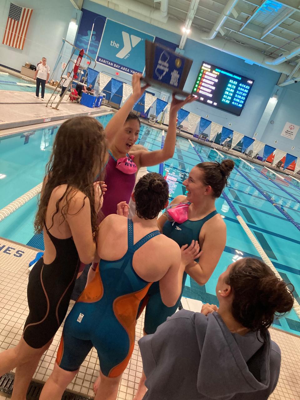 Chatham senior Flora Jeng holds up the NJSIAA Public 2-B swimming trophy. The Cougars defeated Summit on Feb. 16, 2023.