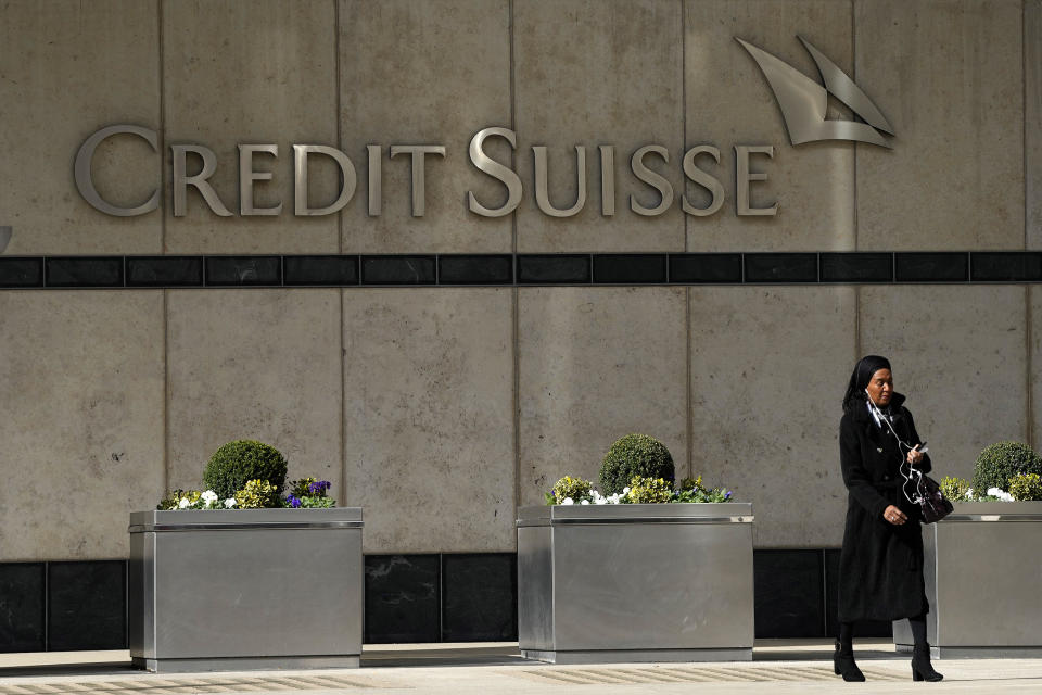 A woman walks past the Credit Suisse bank headquarters in London, Thursday, March 16, 2023. / Credit: Frank Augstein / AP