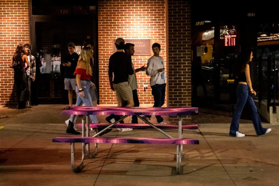 People walk along Washington Street during the coronavirus pandemic Saturday in downtown Iowa City, Iowa.