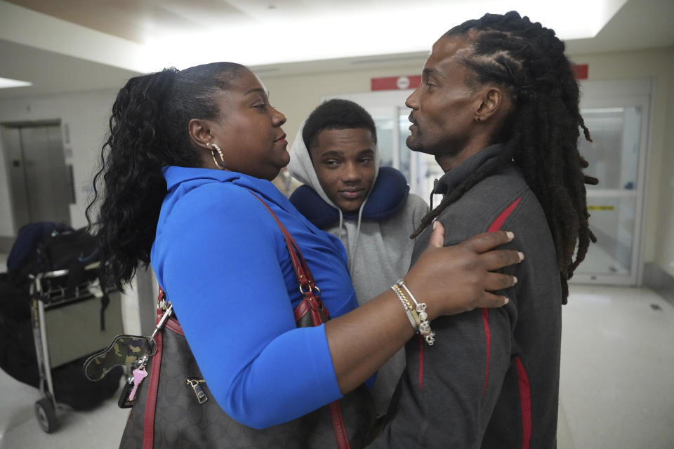 Valerie Laveus greets her brother Reginald Malherbe Daniel and her nephew Tristan-Ryan Malherbe Daniel as they arrive for the first time to the United States from Haiti at Fort Lauderdale-Hollywood International Airport, in Fort Lauderdale, Fla., Wednesday, Aug. 9, 2023. (AP Photo/Jim Rassol)