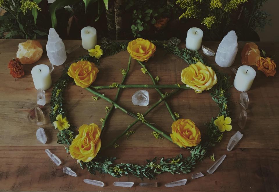 Un arreglo floral con un pentagrama, un altar que sería común en la práctica Wicca para honrar a los cinco elementos. (Wikimedia Commons)