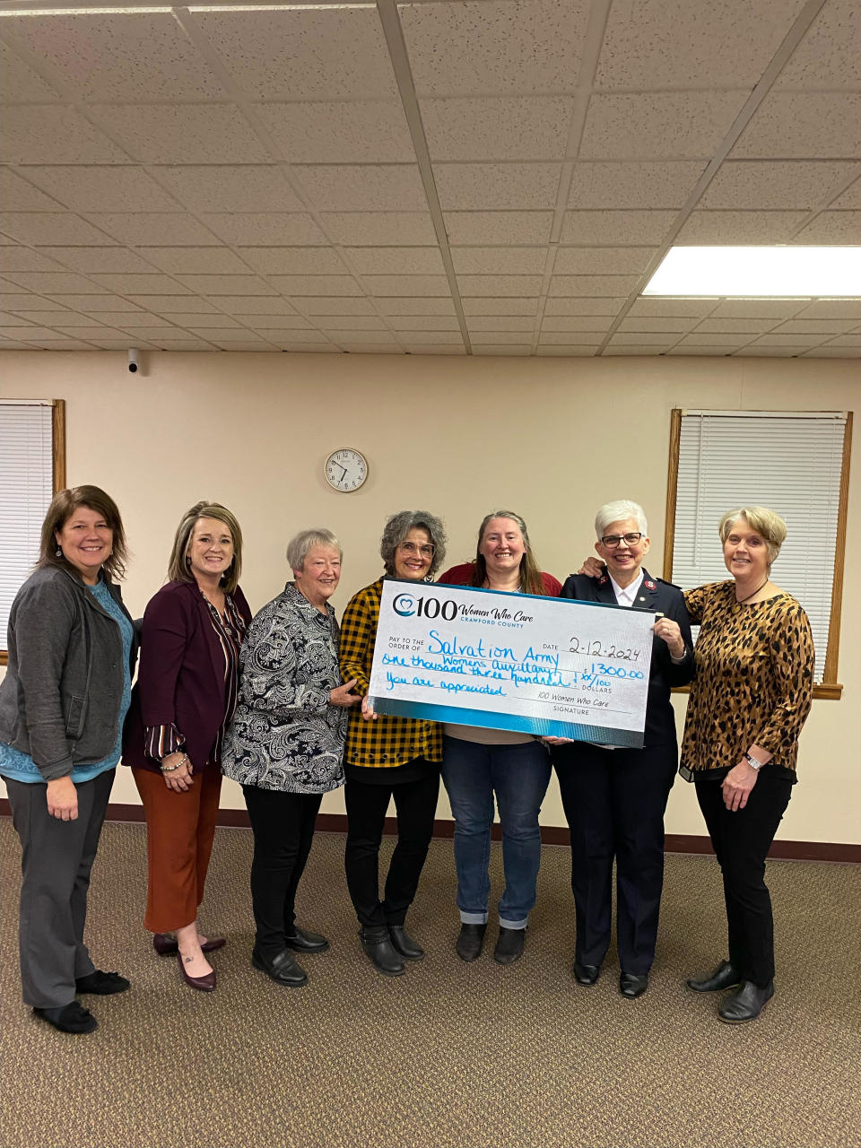 The Crawford County group 100 Woman Who Care presented a check to the Salvation Army to support the Kicks for Kids program. Paula Brown, left, Miki Zeiger, Mary Jo Carle, Susan Maynard, Tabetha Linn, Major Debbra Grace and Thresa Young were present when the funds were presented.