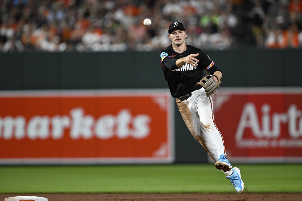 Baltimore Orioles shortstop Gunnar Henderson throws to first base for an out on a ground ball hit by Texas Rangers' Leody Taveras during the seventh inning of a baseball game, Saturday, June 29, 2024, in Baltimore. (AP Photo/Terrance Williams)