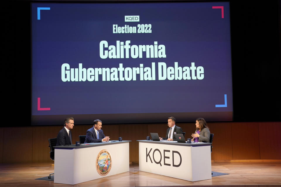 Gubernatorial candidates Democratic Gov. Gavin Newsom, left, and Republican challenger state Sen. Brian Dahle, second from left, take a question from debate co-moderator Marisa Lagos, right, during their debate held by KQED Public Television in San Francisco, Sunday, Oct. 23, 2022. Second from right co-moderator Scott Schafer. (AP Photo/Rich Pedroncelli, Pool)