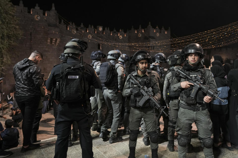 Israeli border police officers stand guard during clashes between Israeli security forces and Palestinians next to Damascus Gate, outside the Old City of Jerusalem, during the Muslim holy month of Ramadan, Monday, April 4, 2022. (AP Photo/Mahmoud Illean)