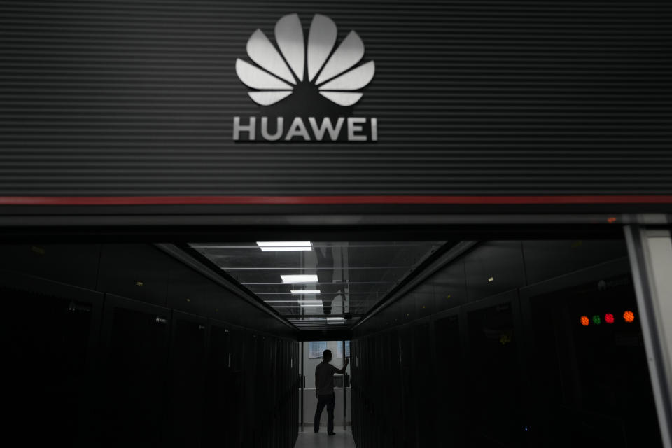 A technician stands at the entrance to a Huawei 5G data server center at the Guangdong Second Provincial General Hospital in Guangzhou, in southern China's Guangdong province on Sept. 26, 2021. Chips are a top priority in the ruling Communist Party's marathon campaign to end China's reliance on technology from the United States and official urgency over that grew after Huawei Technologies Ltd., China's first global tech brand, lost access to U.S. chips and other technology in 2018 under sanctions imposed by the White House. (AP Photo/Ng Han Guan)