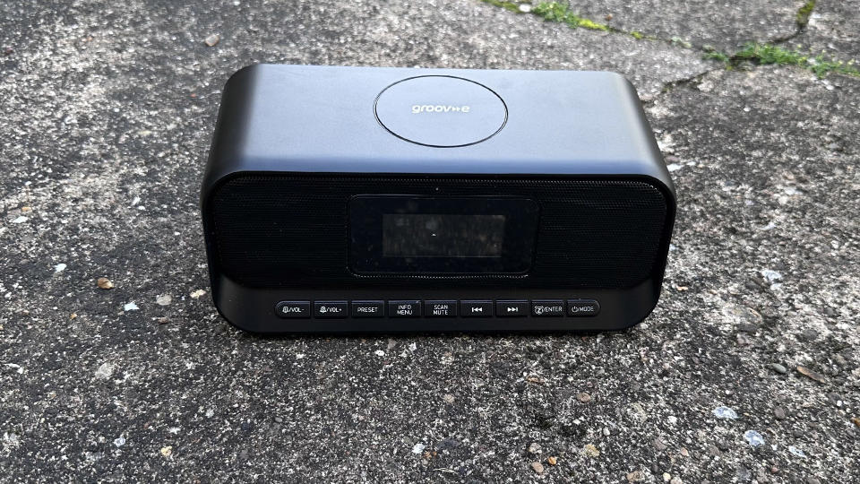 The Groov-E-Zeus DAB FM radio clock against cement