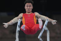 Sun Wei, of China, performs on the parallel barsduring the artistic men's team final at the 2020 Summer Olympics, Monday, July 26, 2021, in Tokyo. (AP Photo/Natacha Pisarenko)