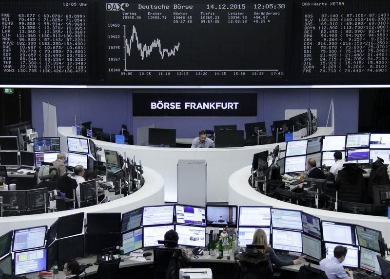 Traders work at their desks in front of the German share price index DAX board, at the stock exchange in Frankfurt, Germany, December 14, 2015. REUTERS/Staff - RTX1YL1L